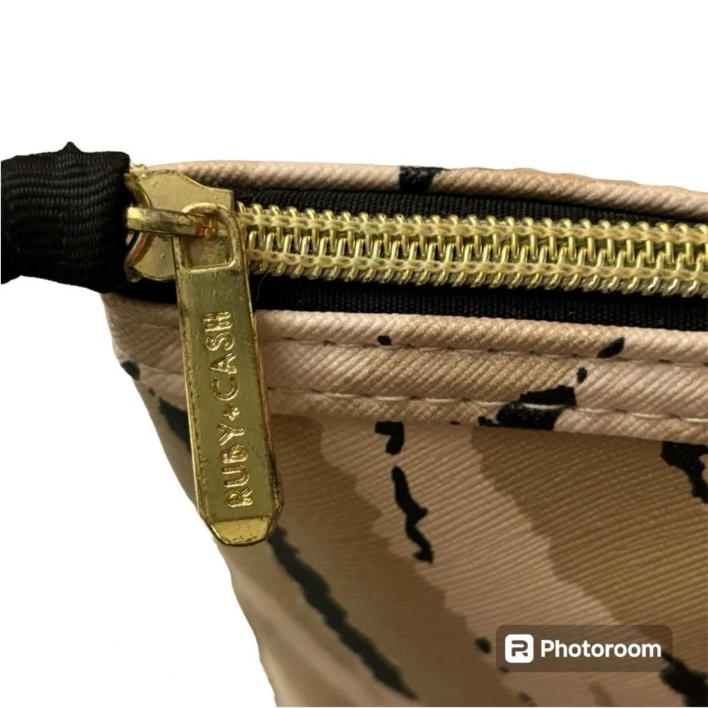 Ruby Cash animal print top zipper makeup bag. Black, tan and cream.